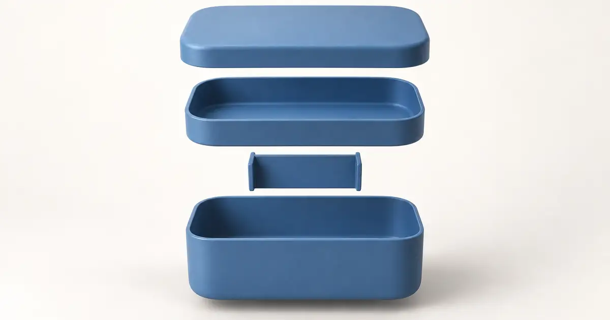 A simple blue bento box shown with its lid, tray, removable divider, and lower container separated vertically