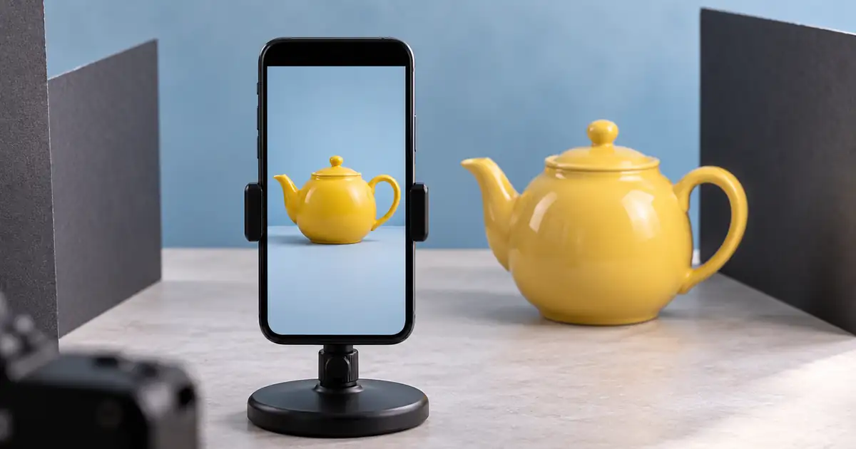A phone displaying a centered yellow teapot with generous space around the subject